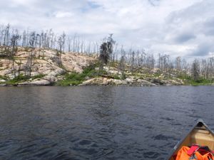 Cached fishing boats on Rostoul Lake 100m SW of Portage trail