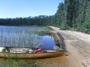Sandy beach on west side of Kilburn Lake Portage looking north