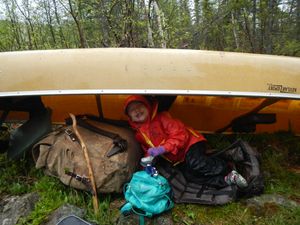 Hiding under canoe