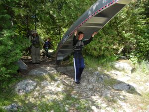 Joseph Portaging Canoe